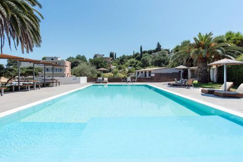 a swimming pool with blue water in a resort at Anita in Perama