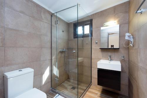 a bathroom with a shower and a toilet and a sink at Anita in Perama