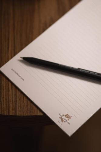 a pen sitting on top of a piece of paper at I Portici Hotel Bologna in Bologna