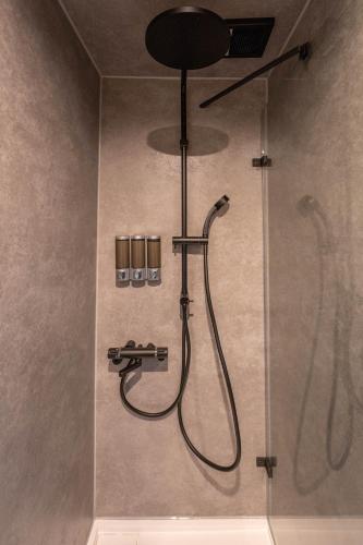 a shower with a shower head in a bathroom at KAON Taisho renovated 100-year-old private house in Osaka