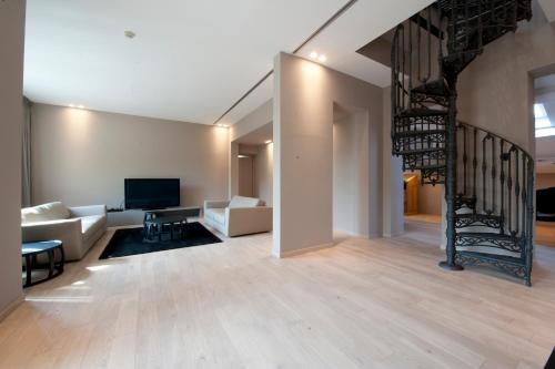 a living room with a staircase leading to a living room at I Portici Hotel Bologna in Bologna