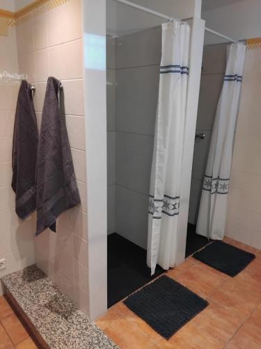 a bathroom with a shower with a glass door at Magnolia l'Escala 1, casa con piscina y barbacoa a 300m de la playa in L'Escala