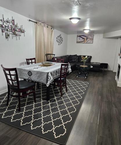 a living room with a table and chairs and a couch at Queen bedroom in Toronto