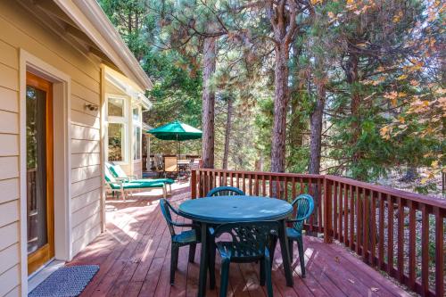 a patio with a table and chairs on a deck at Miller's Landing in Wawona