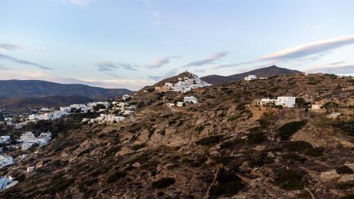 a group of buildings on top of a mountain at Heliopetra Punta in Ios Chora