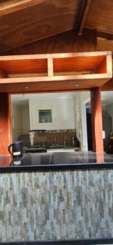 a kitchen with a sink and a large mirror at Casa Independiente Los Conquistadores Av Principal Valdivia Rene Schneider in Valdivia