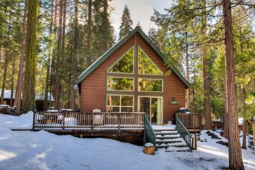 a log cabin in the woods in the snow at Wawona Chalet in Wawona