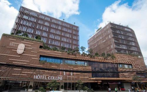 a hotel building with two tall buildings at Reply 1996 Apartment in DaLat Center in Da Lat