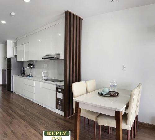 a kitchen and dining room with a table and chairs at Reply 1996 Apartment in DaLat Center in Da Lat