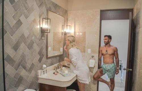 a man and a woman standing in a bathroom at Casa Lucia Hotel Boutique in Mérida