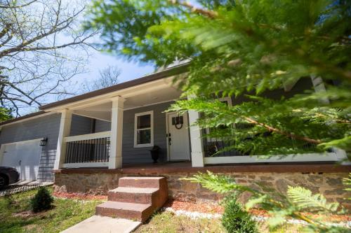 a house with a porch and stairs in front of it at Incredible King Bed Room Private Bathroom in Lithonia