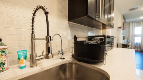 a kitchen counter with a sink and a faucet at Incredible King Bed Room Private Bathroom in Lithonia