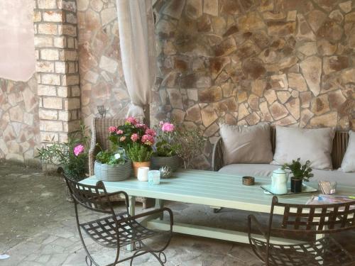 a table with chairs and a couch on a patio at Vila Anna in Želízy