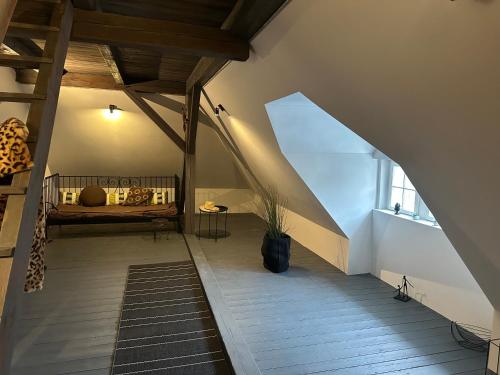 an attic room with a bed and a window at Vila Anna in Želízy