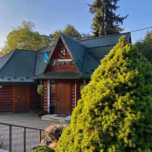 a building with a sign on the front of it at Водограй in Vorokhta