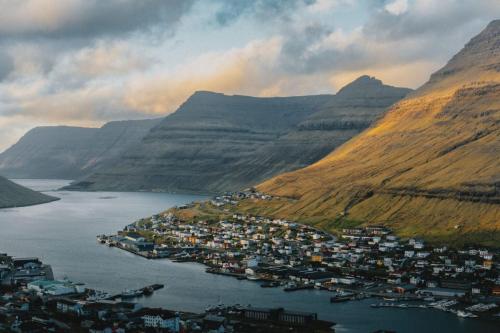 an aerial view of a town in the middle of a mountain at Cozy apartment in Klaksvík