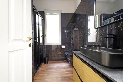 a bathroom with a sink and a toilet at Stella Polare Sensorial Home in Lido di Ostia