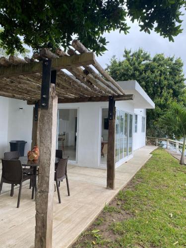 an outdoor deck with a pergola and a table at Los Veleros 2 in Ceiba Rica