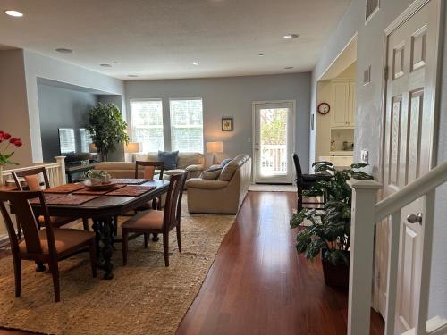 a dining room and living room with a table and chairs at Strawberry Fields Forever Oxnard Beauty in Oxnard