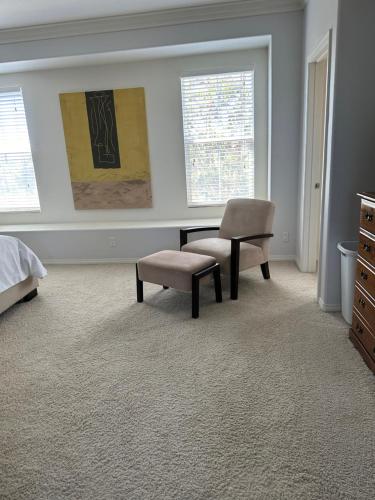 a bedroom with a desk and a chair at Strawberry Fields Forever Oxnard Beauty in Oxnard