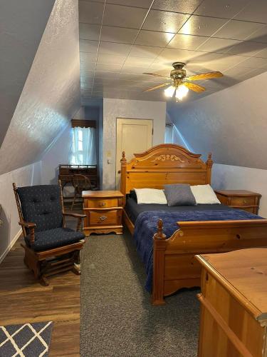 a bedroom with a wooden bed and a chair at Diamond Apartment with GYM - 2 miles to Fort Sill & just blocks to downtown! in Lawton
