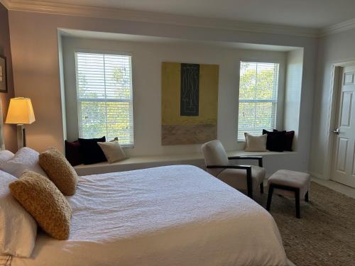 a bedroom with a white bed and a living room at Strawberry Fields Forever Oxnard Beauty in Oxnard