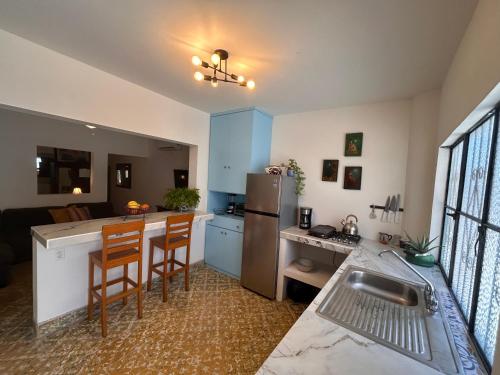 a kitchen with a refrigerator and a counter top at Depas Azules Zona Centro Apt B in Mazatlán