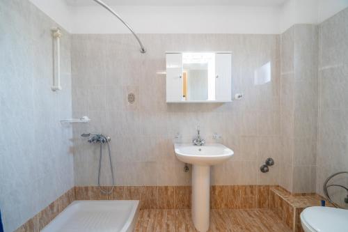 a bathroom with a sink and a shower and a toilet at Lemonia Apartments Kefalonia in Andipáta Erísou