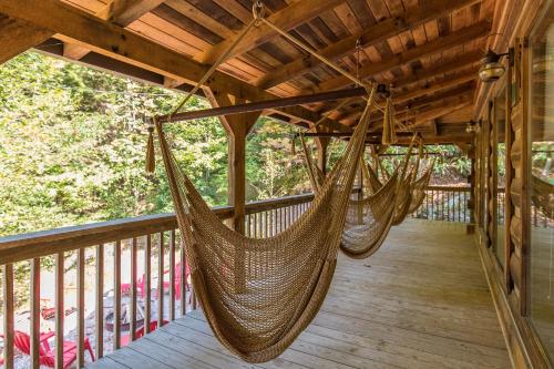 a porch with two hammocks on a deck at Big Boulder Hot Tub Private Hiking in Rogers