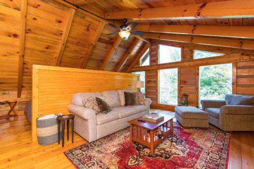 a living room with a couch and a table at Big Boulder Hot Tub Private Hiking in Rogers