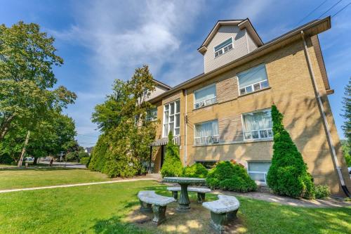 a building with a picnic table in front of it at Elegant Brand New Apartment in Central Burlington in Burlington