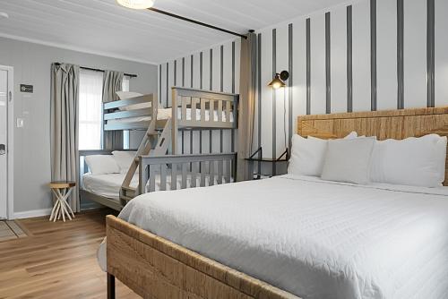 a bedroom with a bed and a bunk bed at Seabirds Motel At Kure Beach in Kure Beach