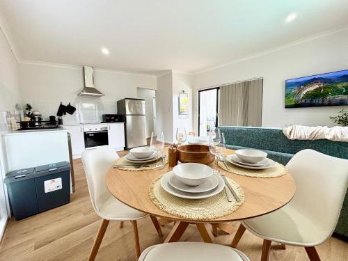 a kitchen and dining room with a table and chairs at Joondalup Hidden Villa Gemma W Pool! in Perth