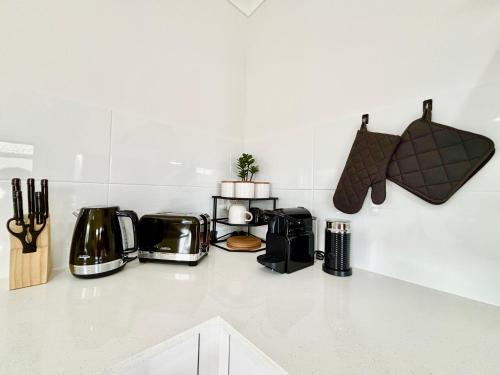 a kitchen counter with several appliances on it at Joondalup Hidden Villa Gemma W Pool! in Perth