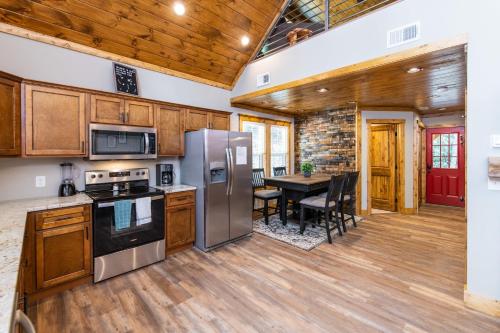 a kitchen with stainless steel appliances and a table at Angel's View in Rogers