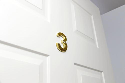 a door with a brass number six on it at Stella Polare Sensorial Home in Lido di Ostia