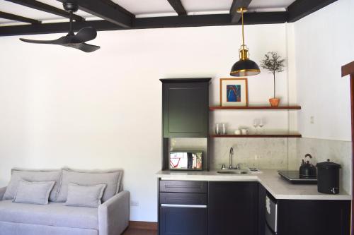 a kitchen with a couch next to a kitchen counter at Villa Cristal in Antigua Guatemala