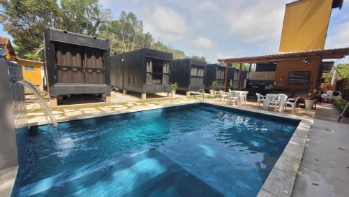 a swimming pool in a backyard with a house at Aldeia Mar in Bertioga