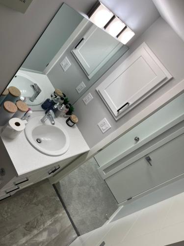 an overhead view of a bathroom with a sink and mirror at Private Basement Suite with comfort in Winnipeg