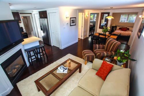 a living room with a couch and a fireplace at Grand Boulevard Retreat- quiet suite in North Vanc in North Vancouver