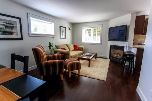 a living room with a couch and a fireplace at Grand Boulevard Retreat- quiet suite in North Vanc in North Vancouver
