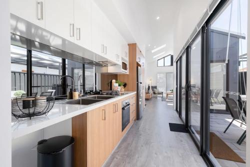 a kitchen with wooden cabinets and a large window at Living luxe in Yokine - King bed and FREE parking in Perth