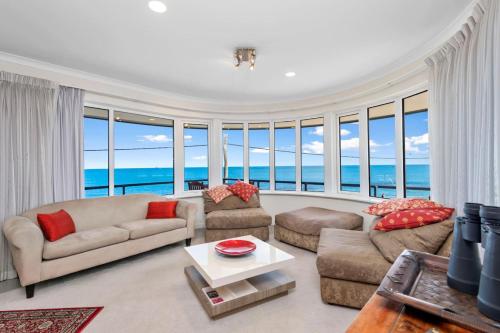 a living room with a couch and a table at Endless Summer - The Reefs in Perth