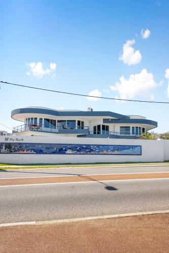 a building on the side of a road next to a road at Endless Summer - The Reefs in Perth