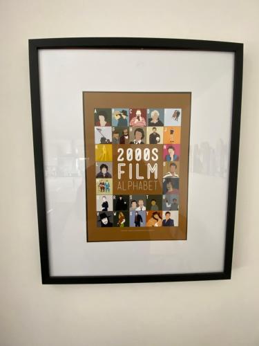 a picture frame hanging on a wall in a room at Rooftops Apartment in Bletchley