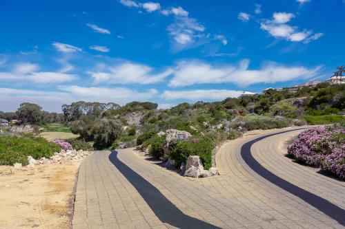 a winding road with purple flowers on a hill at A6 - Work-from-home haven - free WIFI - 1BR in Perth