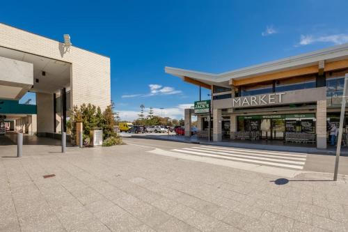 an empty street in front of a shopping center at A6 - Work-from-home haven - free WIFI - 1BR in Perth