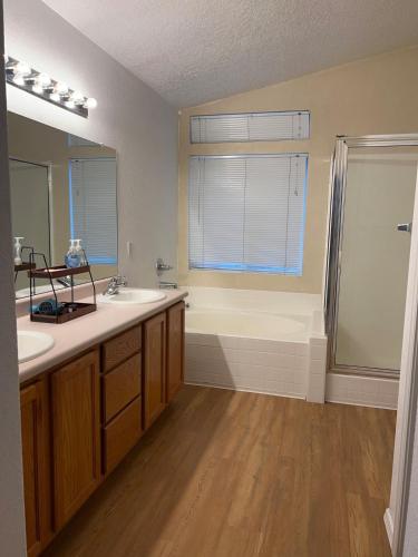 a bathroom with a tub and a sink and a shower at Paradise Skies in Albuquerque