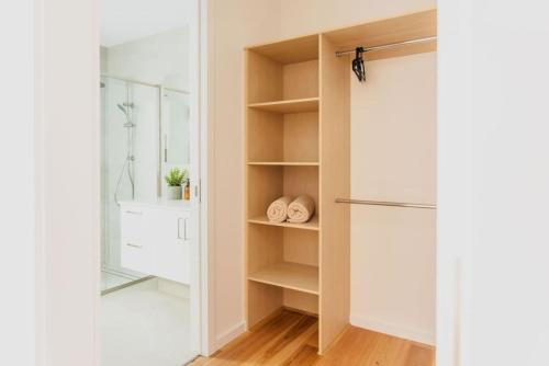 a kitchen with a closet with a refrigerator at Olive Grove - stroll to the beach! in Ocean Grove