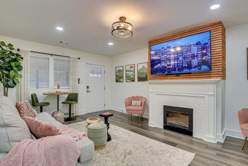 a living room with a fireplace and a large tv at Stylish APT 1mile To Masters 2mi Medical Center in Augusta
